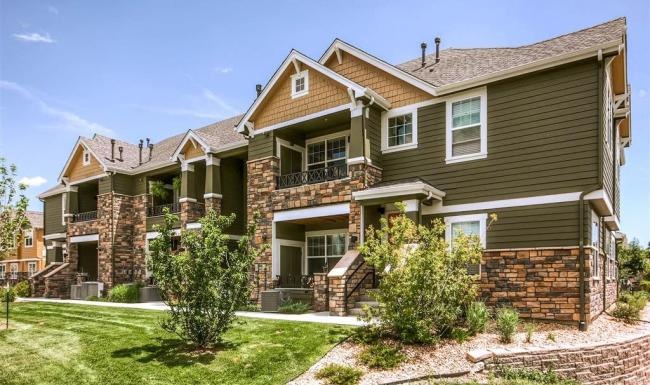 a row of townhomes with a lawn