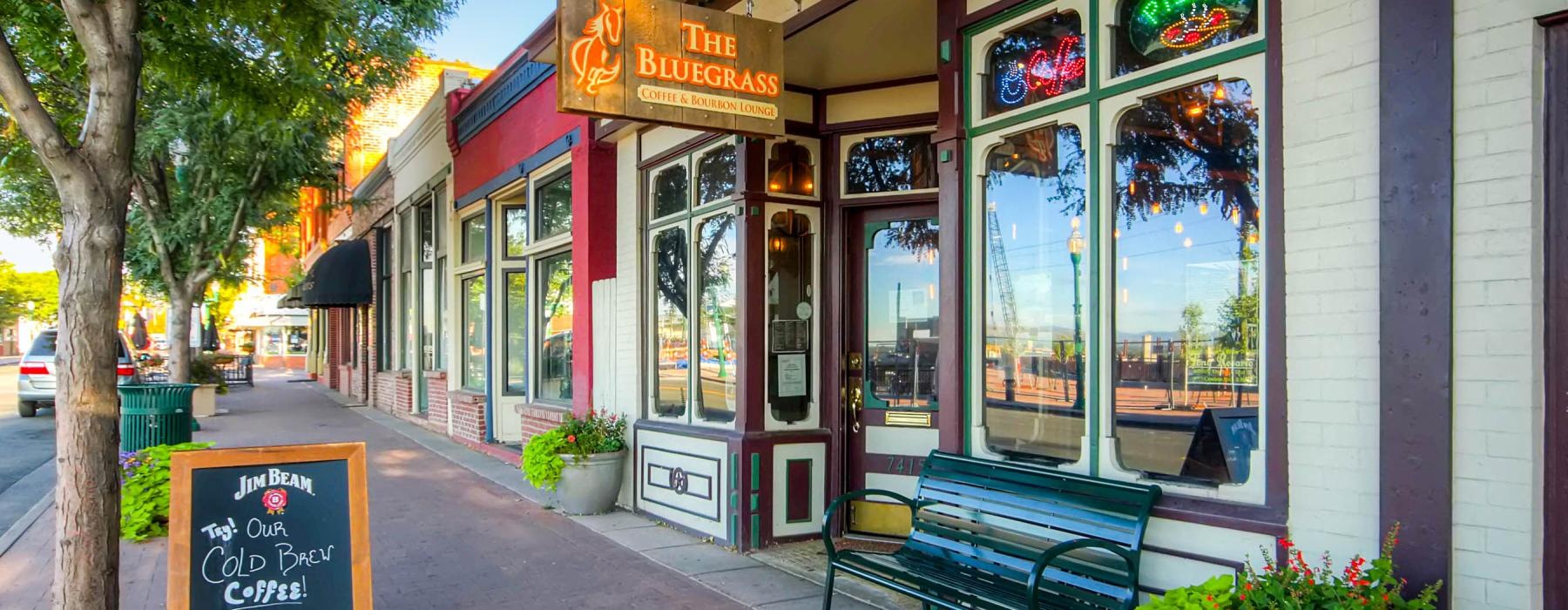 a bench sits in front of a store strip